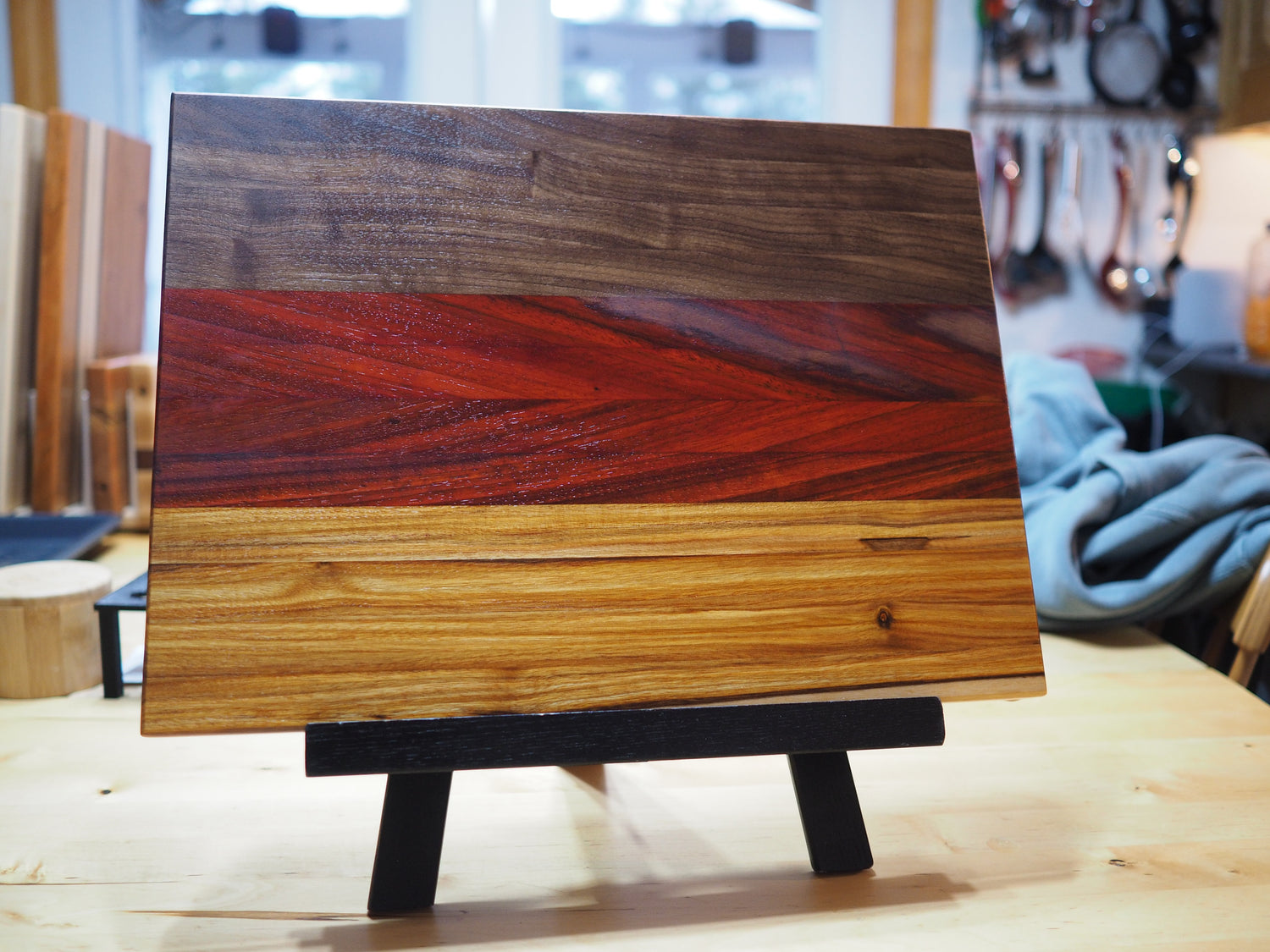 Walnut, sapele and canary wood cutting board, to imitate a German flag
