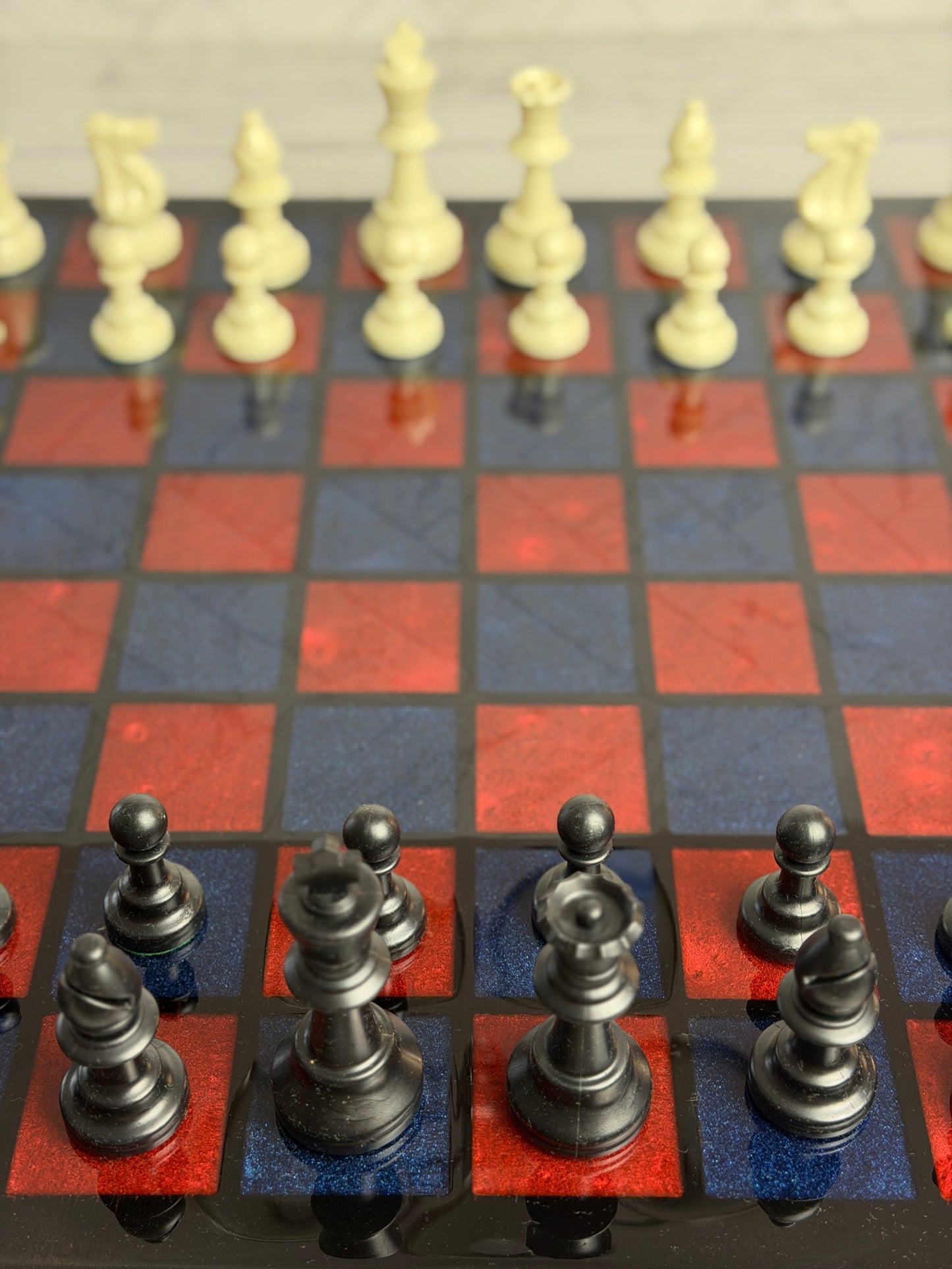 Handcrafted chess board with red and blue epoxy resin inlay squares and classic chess pieces — Bees Boards