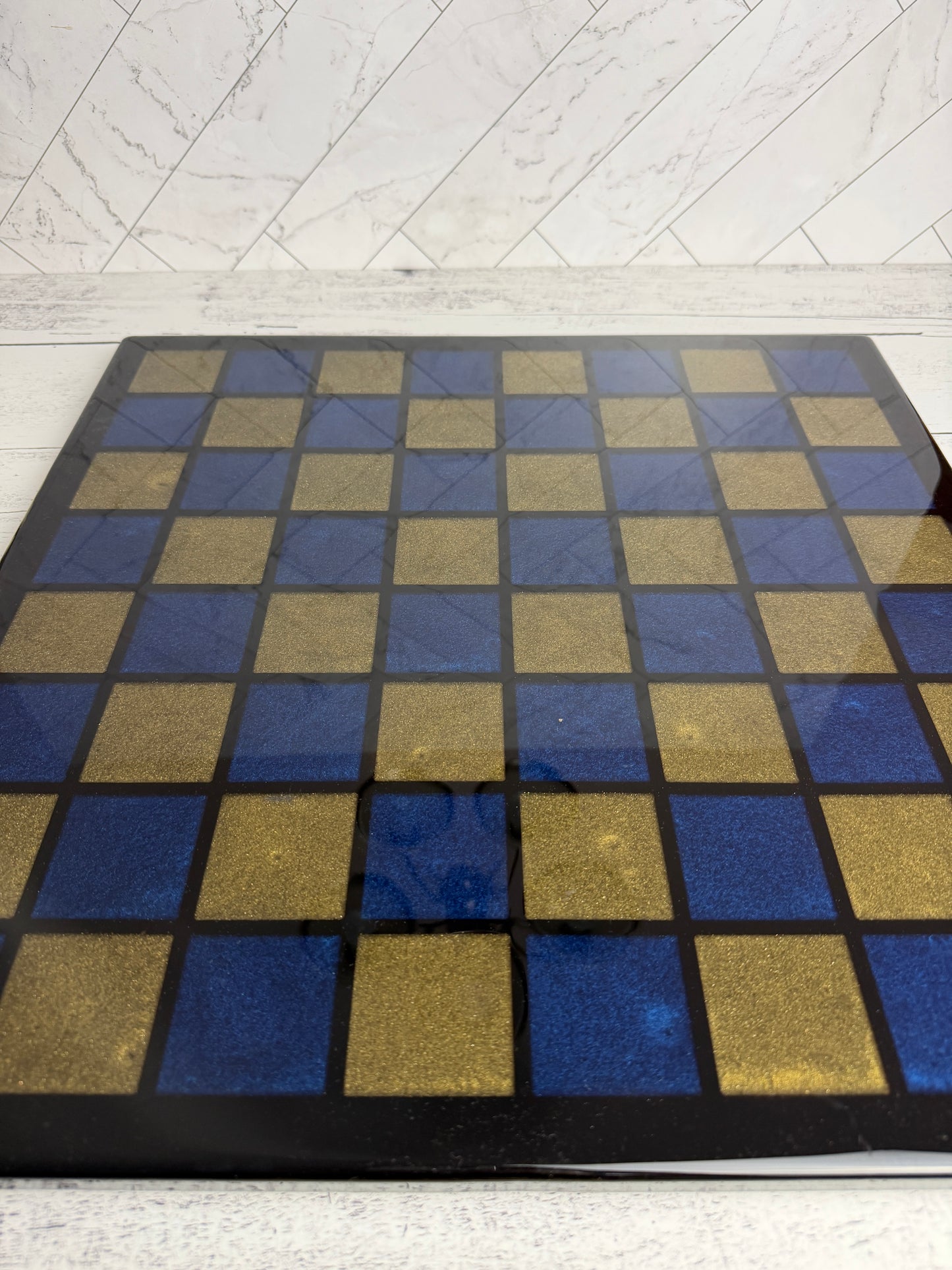 Handcrafted chess board with blue and gold epoxy resin squares on dark wood — Bees Boards