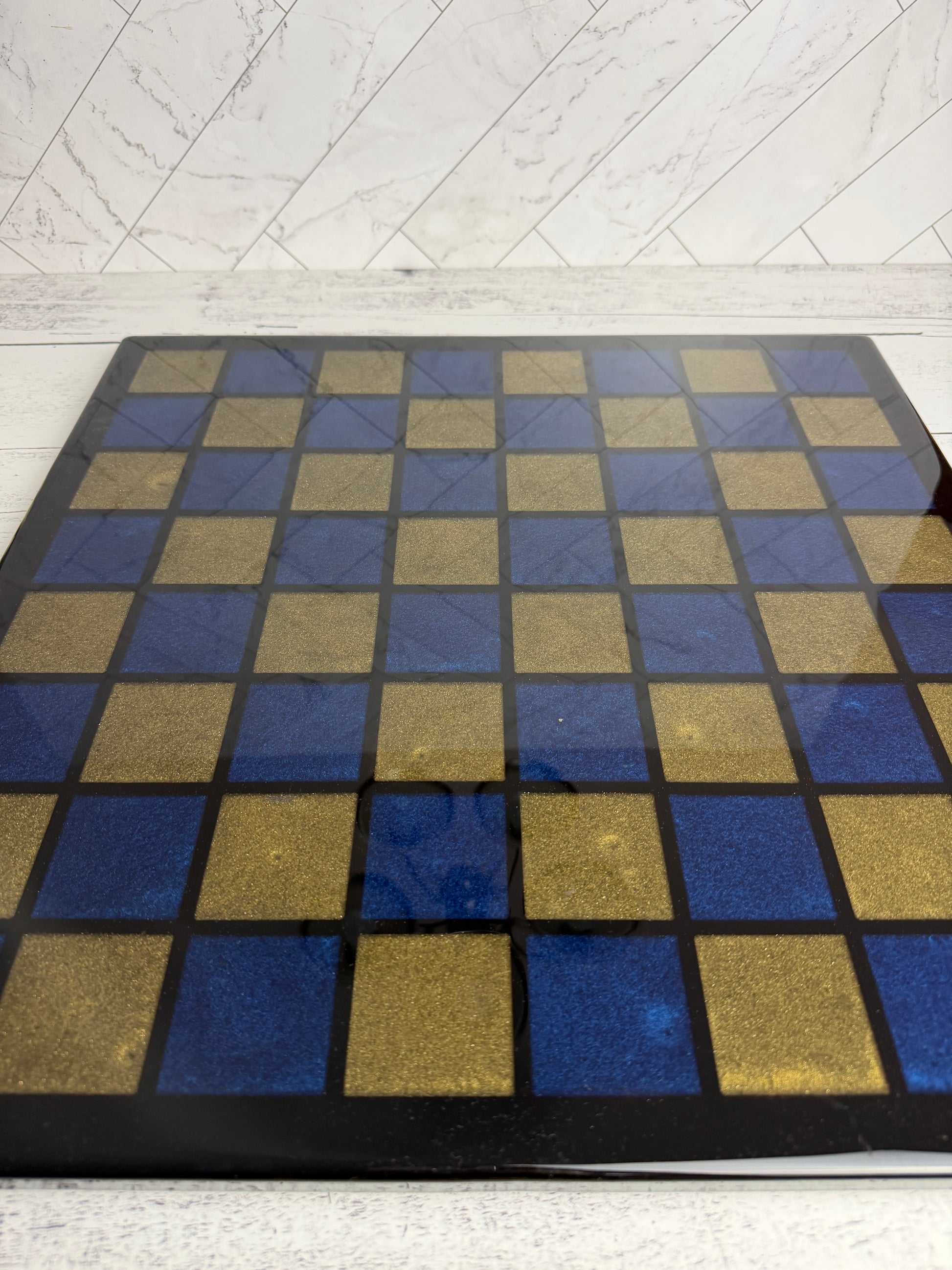 Handcrafted chess board with blue and gold epoxy resin squares on dark wood — Bees Boards
