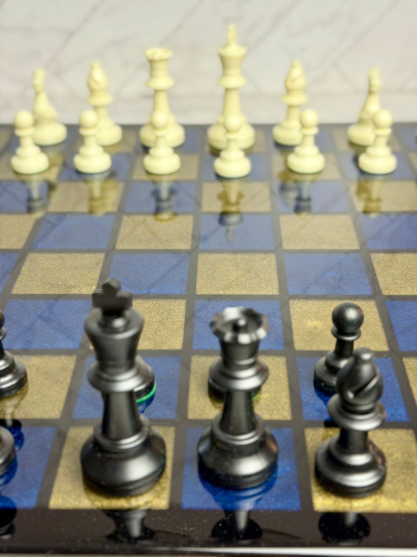 Glossy resin-poured chess board with blue and gold epoxy squares and metallic chess pieces — Bees Boards